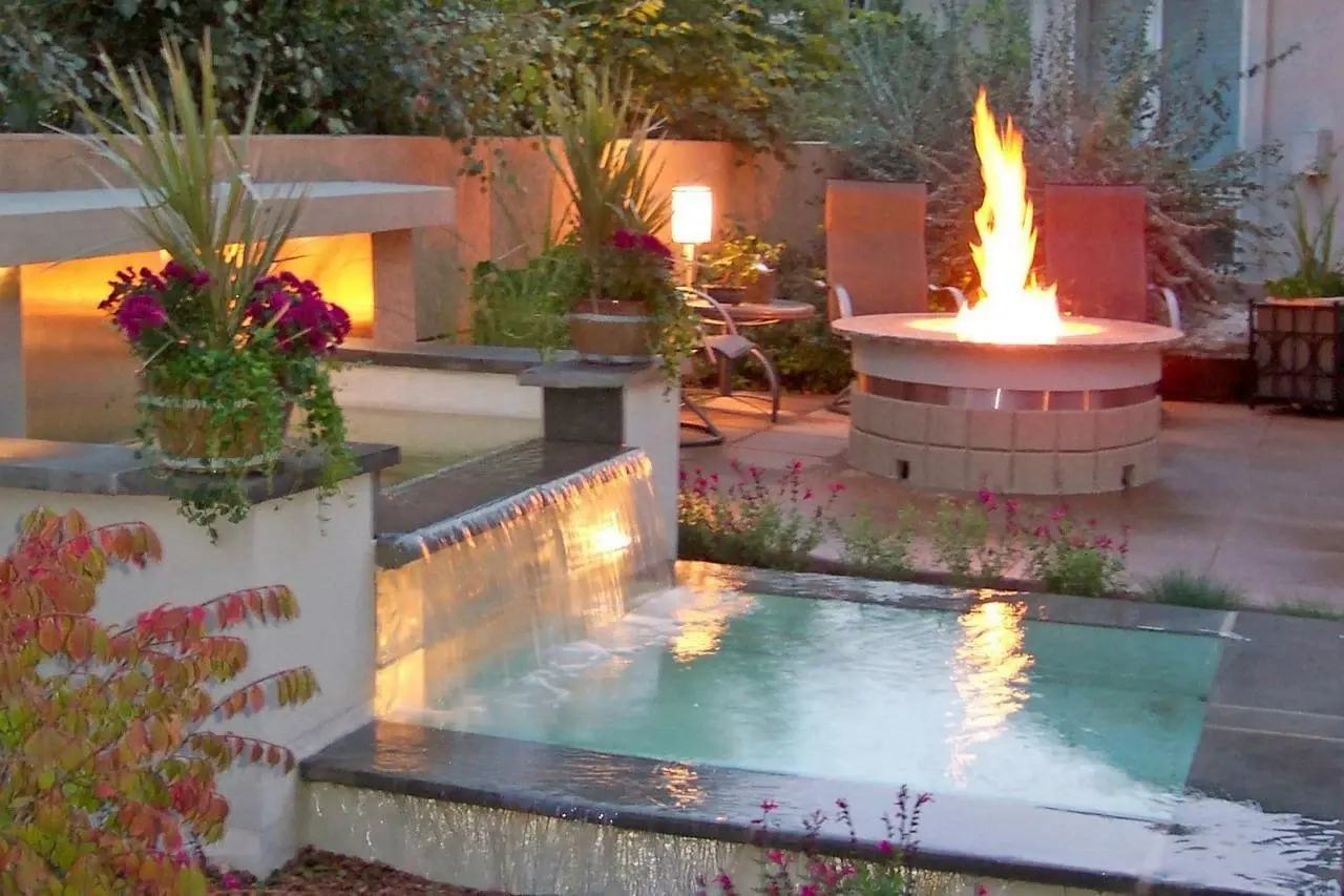Circular rugged masonry fire pit with integrated stone seating